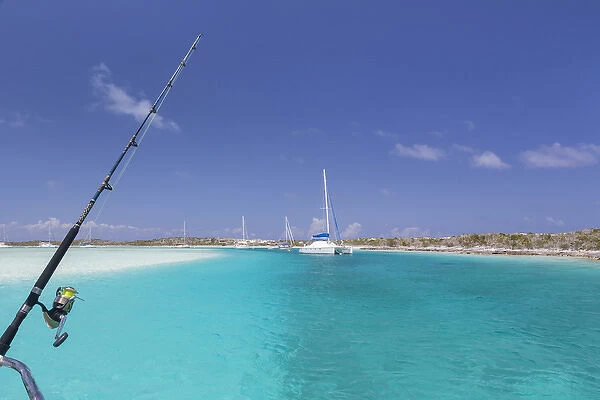 Bahamas, Exuma Island, Cays Land and Sea Park. Moored sailboats and fishing rod. Credit as