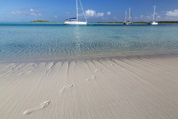 Bahamas, Exuma Island, Cays Land and Sea Park. Sand footprints and moored sailboats