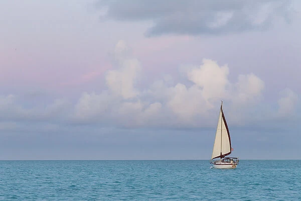 Bahamas, Exuma Island. Sailboat at sunset. Credit as: Don Paulson  /  Jaynes Gallery  /  DanitaDelimont