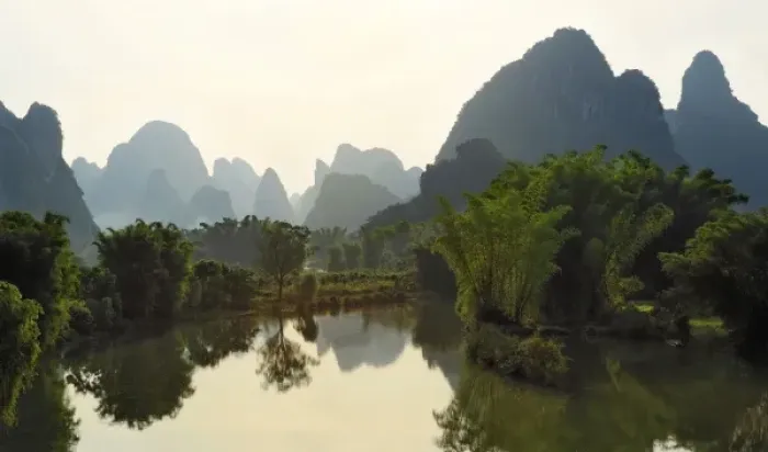 Framed Print : Bamboo and karst formations reflected in small pond along the Yulong River, China Framed Print : Bamboo and karst formations reflected in small pond along the Yulong River, China