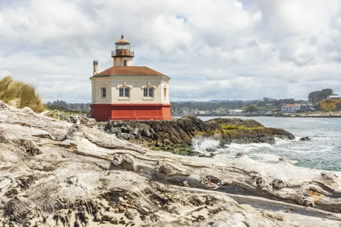 Framed Print : Bandon, Oregon, USA. Beach logs and the Coquille River Lighthouse on the Oregon coast