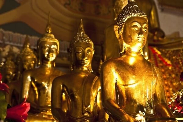 Bangkok, Thailand - Row of ornate, golden Buddhist statues in a temple