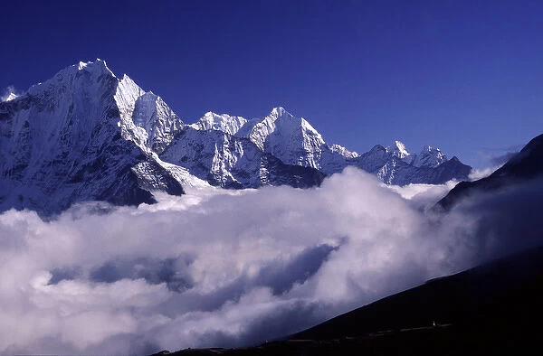 A bank of heavy clouds rolls up the Gokyo Valley underneath high Himalayan peaks