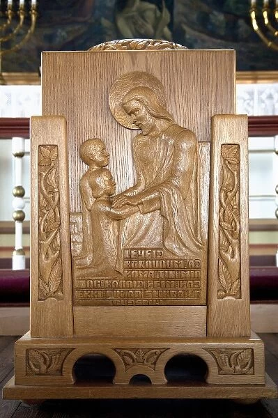 Baptismal font, town church of Husavik, Iceland shows Christ adoring little children