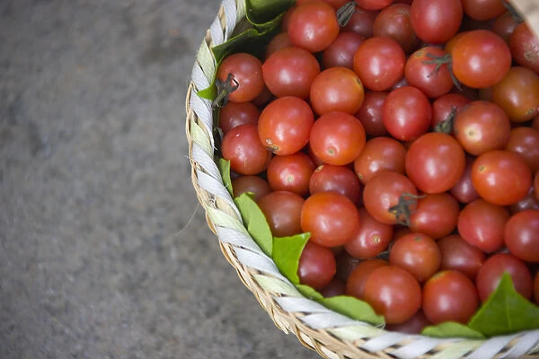Basket of tomatoes, China