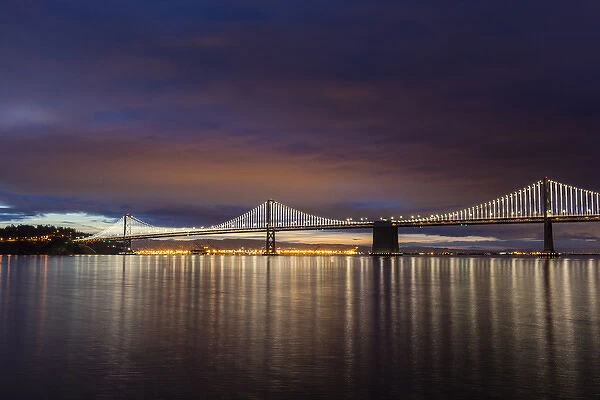 The Bay Bridge reflects at dawn in San Francisco, California, USA