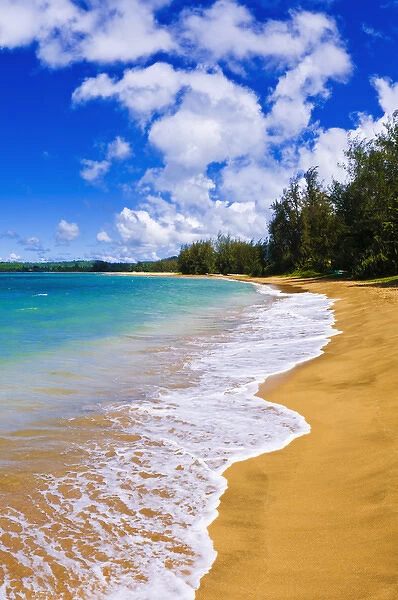 Empty beach and blue Pacific waters on Hanalei Bay, Island of Kauai, Hawaii
