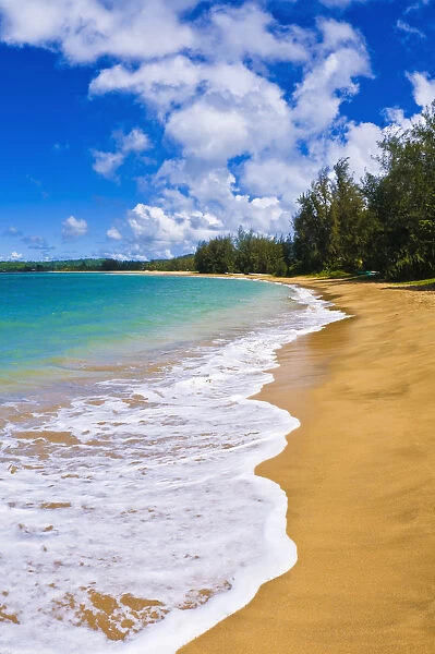 Empty beach and blue Pacific waters on Hanalei Bay, Island of Kauai, Hawaii, USA