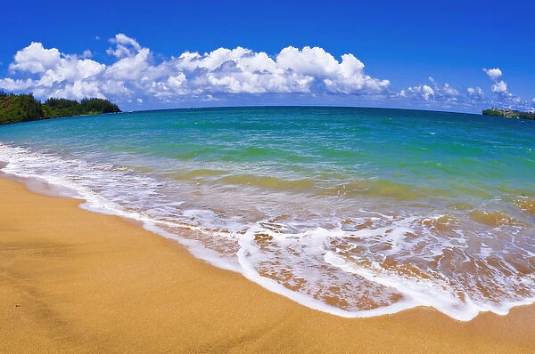 Empty beach and blue waters on Hanalei Bay, Island of Kauai, Hawaii
