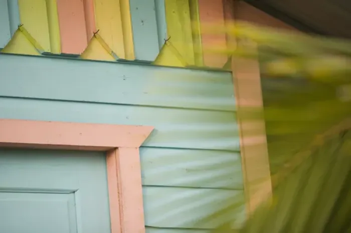 Framed Print : Detail of beach house painted in pastel colors and palm tree, Placencia, Stann Creek District