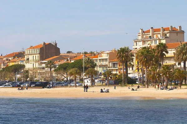 The beach with palm trees and houses along the coast in Bandol. Bandol Cote daaAzur