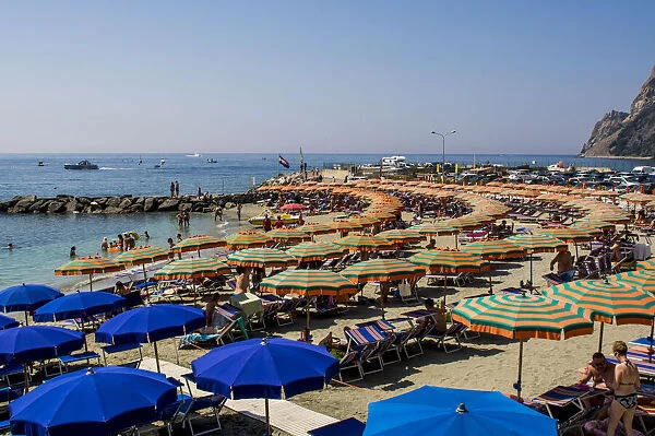Beach umbrellas lining the beach in Monterosso al Mare, Cinque Terre, Italy