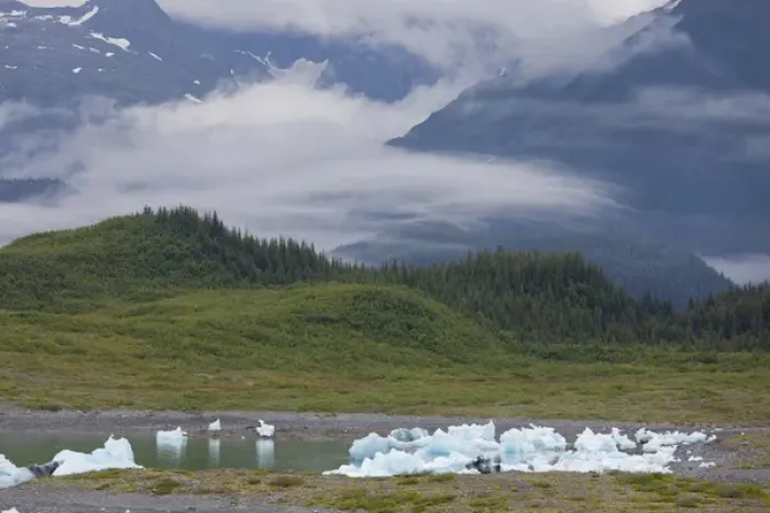 Framed Print : Beached icebergs sit in Columbia Bay at the foot of the Chugach Mountains, on a misty