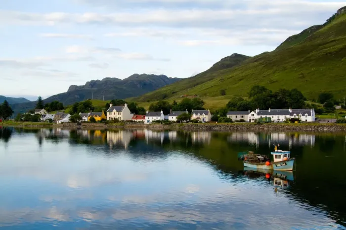 Framed Print : Beautiful photo of small village of Dornie with refections and boat in Western Highlands Framed Print : Beautiful photo of small village of Dornie with refections and boat in Western Highlands