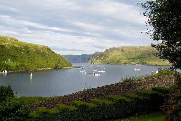 Beautiful port and sailboats with reflections in small tourist village of Portree