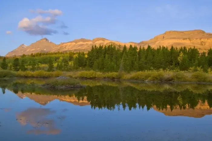 Framed Print : Beaver pond reflects first light on mountain peaks at Marias Pass in Glacier National