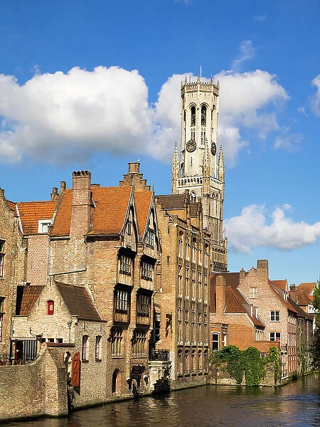 Belgium, Bruges. Belfry of Bruges towers over the buildings at the junction of the Groenerei and Dijver canals