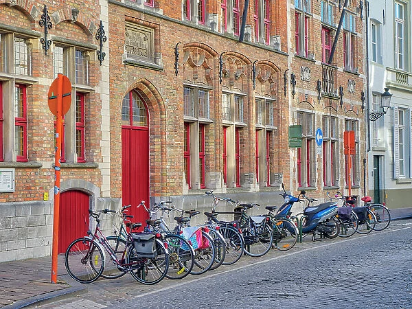 Belgium, Brugge. Bicycles parked along the street