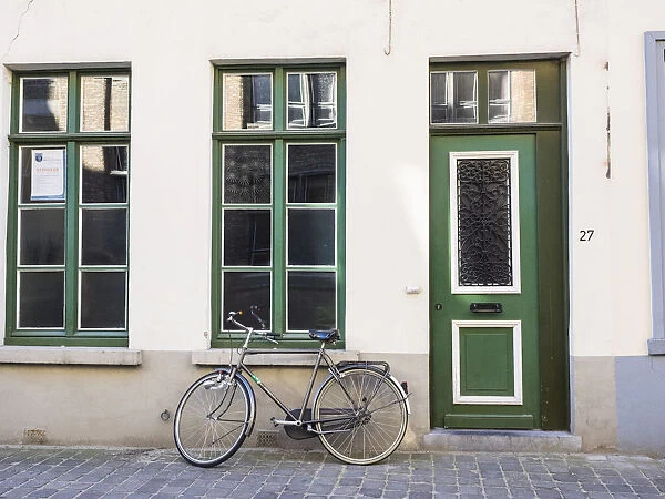 Belgium, Brugge. A bike against a brick wall in Bruges