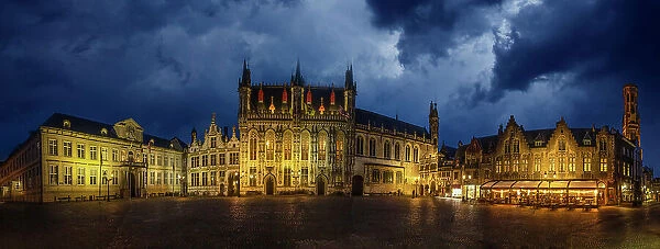 Belgium, Brugge. Panoramic of medieval architecture and square at night