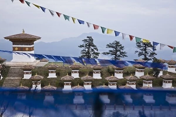 Bhutan, Dochu La. Prayer flags float above 108 stupas at Dochu La pass