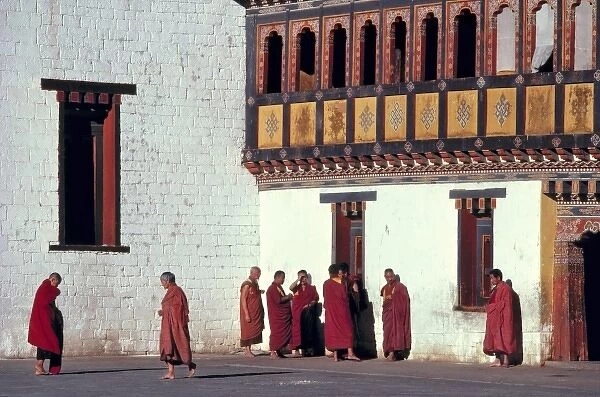 Bhutan, Thimphu. The monks crimson robes stand in brilliant contrast to the