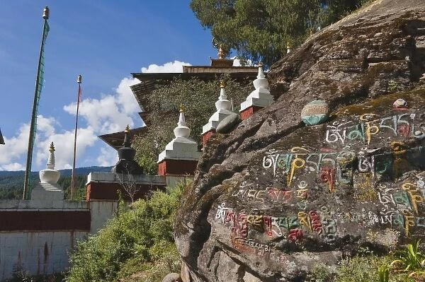 Bhutanese writing on rocks and Nepalese chortens, Kurje Lhakhang, Bumthang, Bhutan