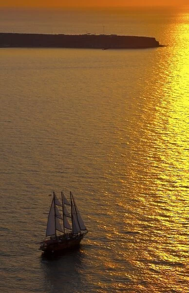 Big masked sailboat sailing in sunset of beautiful Oia in Santorini Greece in Greek