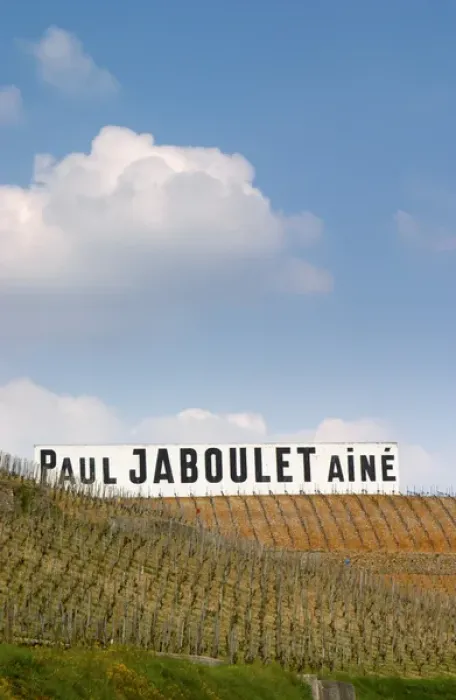 Framed Print : A big white sign with black letters Paul Jaboulet Aine against a blue sky, in front