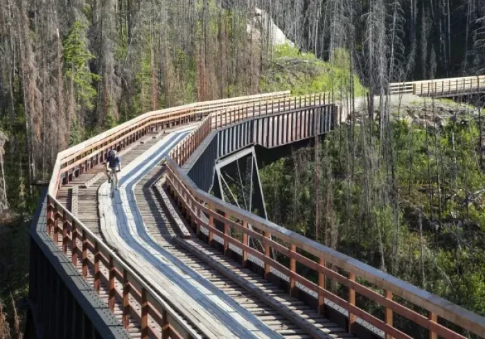 Framed Print : Biker rides across trestle in Myra Canyon on the Kettle Valley Railway bike path near Kelowna Framed Print : Biker rides across trestle in Myra Canyon on the Kettle Valley Railway bike path near Kelowna
