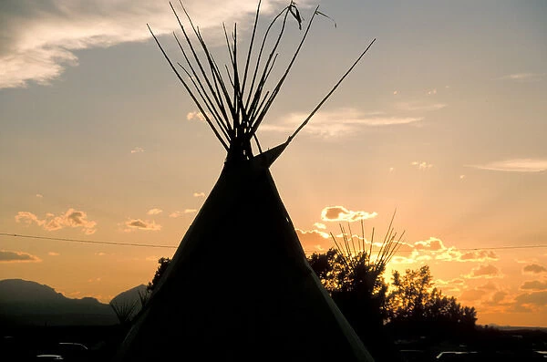 Blackfeet tepees made from canvas stretched over tipi poles at sunset in Browning Montana