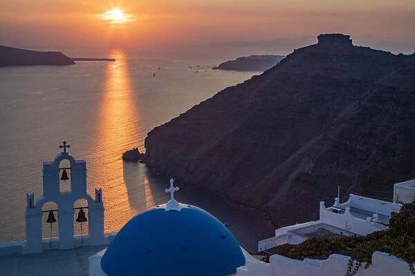 Blue dome church and famous three bells with cross and steeple in Fira, Santorini, Greece