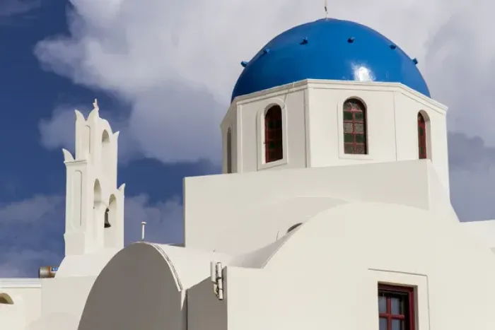 Framed Print : Blue Roofed Churches and homes are everywhere on the Island. Santorini. Greece