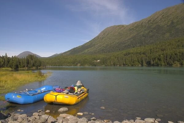 A blue and a yellow rubber raft on the Kenai River along the Sterling Highway in Alaska