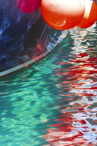 Boat buoys reflect in the water of the Adriatic Sea, Kolocep Island, Croatia