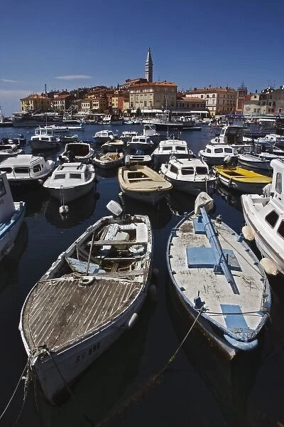 Boats docked in harbor in front of distant Cathedral of St. Euphemia, Rovigno, Croatia