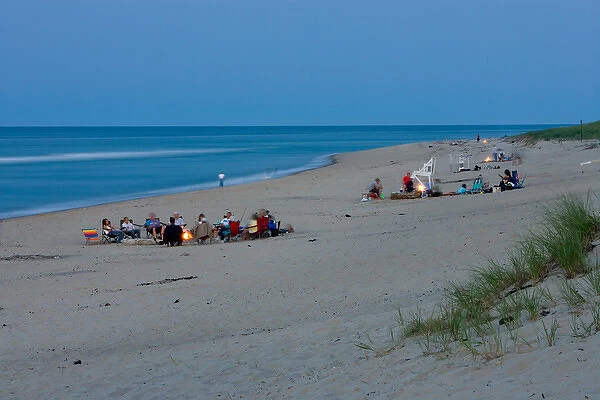 Bonfires burn as night settles in on the beach at the Cape Cod National Seashore in Truro