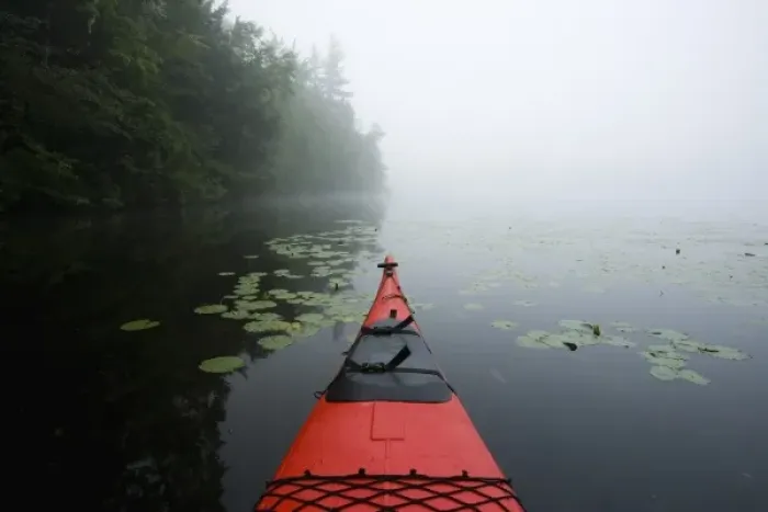 Framed Print : The bow of a kayak on a foggy morning on Mirror Lake in Woodstock, NH. Hubbard Brook
