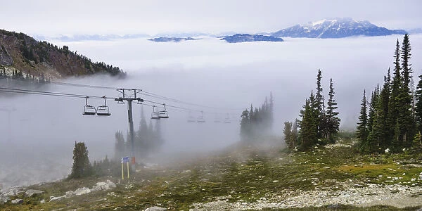 British Columbia, Whistler. Chairlift coming out above the clouds on Whistler Mountain