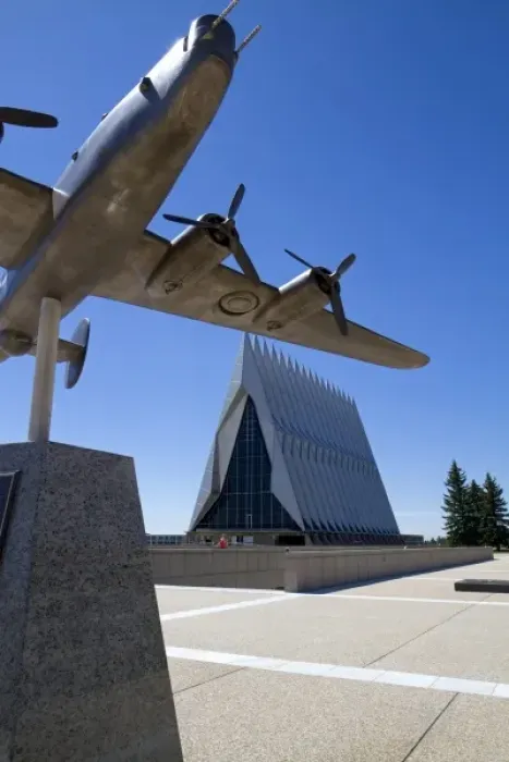 Framed Print : Bronze sculpure of vintage WW11 aircraft in front of the Cadet Chapel at the Air Framed Print : Bronze sculpure of vintage WW11 aircraft in front of the Cadet Chapel at the Air