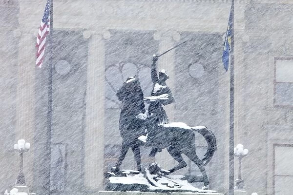 Bronze statue of Thomas Meagher in heavy snowfall in front of Montana State Capitol