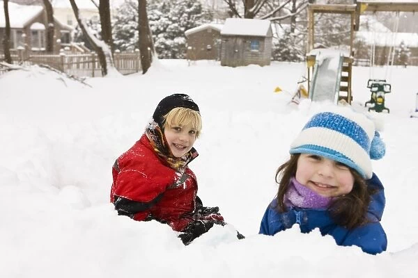 A brother and sister play in a snow fort in their backyard in Portsmouth, New Hampshire