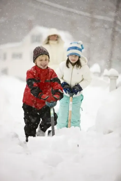 Framed Print : A brother and sister shovel snow during a snowstorm in Portsmouth, New Hampshire Framed Print : A brother and sister shovel snow during a snowstorm in Portsmouth, New Hampshire