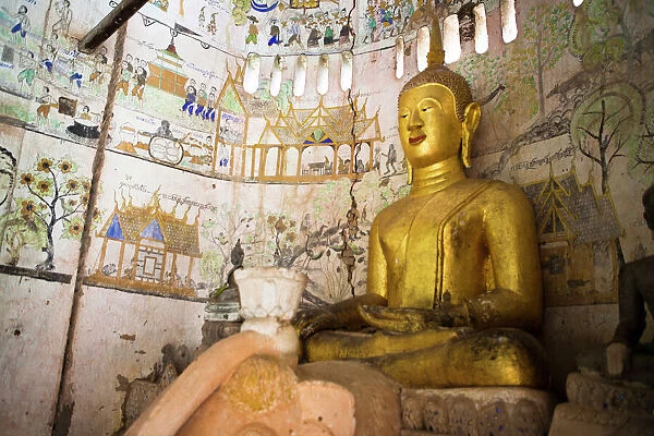 A buddha sits in an ancient buddhist temples in Xe Champhone, Laos