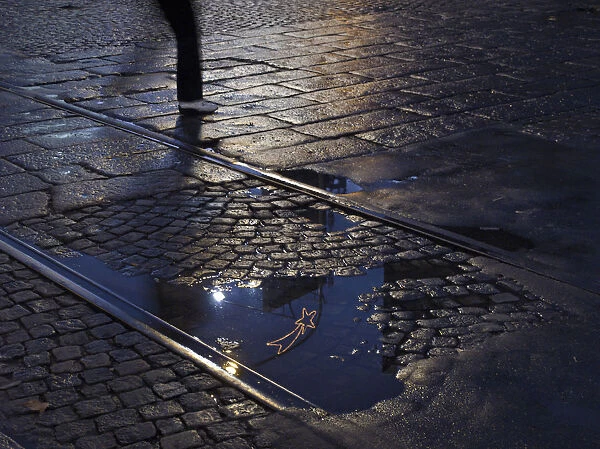 Buenos Aires, Argentina, street pavement and reflection in puddle, dismissed tramway