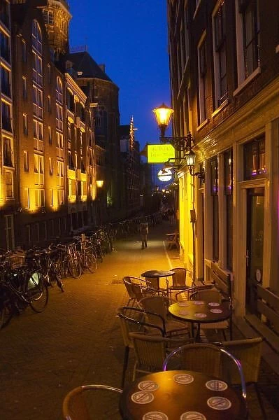 Buildings with 17th or 18th century facade and narrow lane at night, Amsterdam, Netherlands