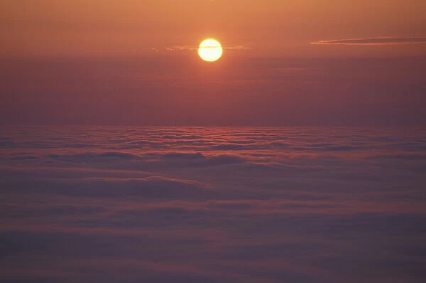 Cadillac Mountain, Acadia N. P. ME. The sun rises over a fog enshrouded Frenchman Bay