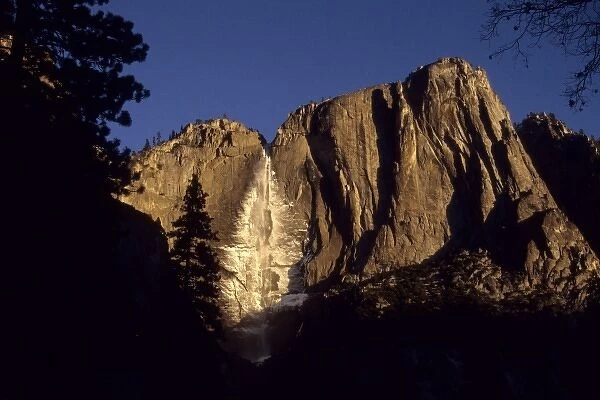 California: Yosemite National Park, Yosemite Falls, snow from mist on cliffs at sunset