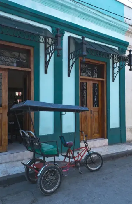 Framed Print : Camaquey Cuba street scene of old bike carriage on street and buildings Framed Print : Camaquey Cuba street scene of old bike carriage on street and buildings