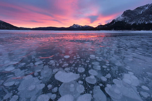 Canada, Alberta, Abraham Lake. Winter sunrise over lake and Mount Michener. Credit as